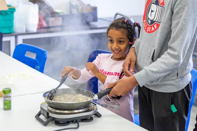 Elynn Furtado (6) cooks a risotto at the Good Grub Club. Picture: Mike Cooter (231022)