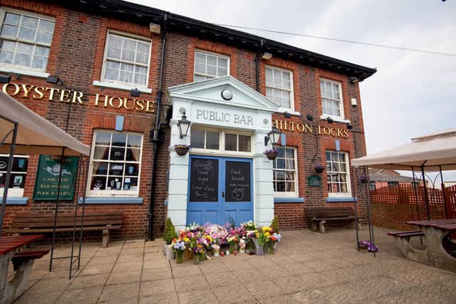 Locals have left floral tributes outside the Old Oyster House 
Picture: Habibur Rahman