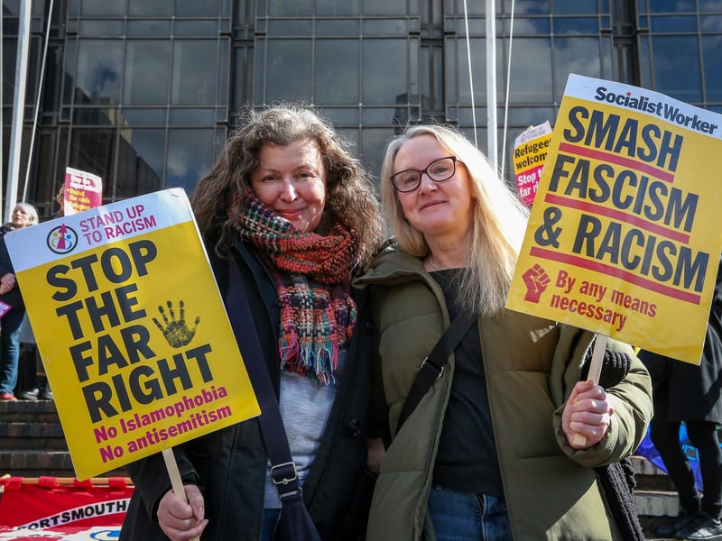 Two counter-protestors proudly hold up their signs. Picture: Chris Moorhouse (150325-041)