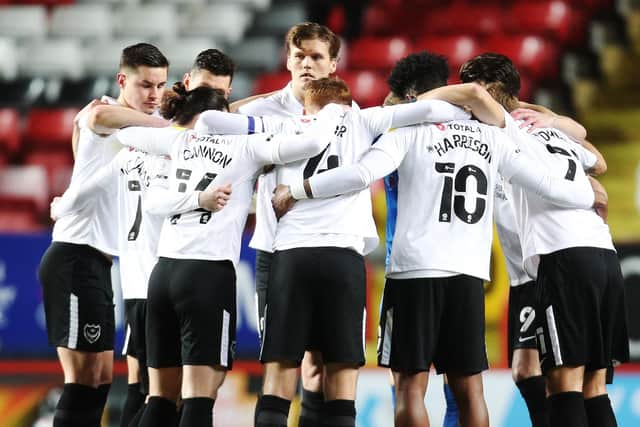 Pompey players huddle. Picture: Joe Pepler