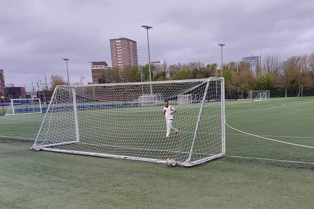 A US Portsmouth fielder retrieves the ball from the back of a goal net at HMS Temeraire.