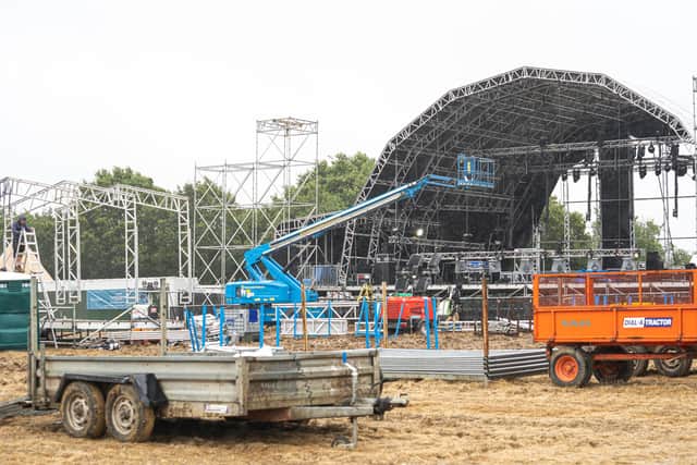 The main stage, still being built (behind because of the weather), as management decide to leave it closed for the first day.
Picture: Andy Hornby