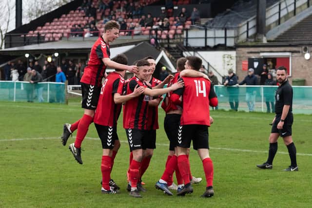 Fareham celebrate one of their three goals against Lymington. Picture: Duncan Shepherd