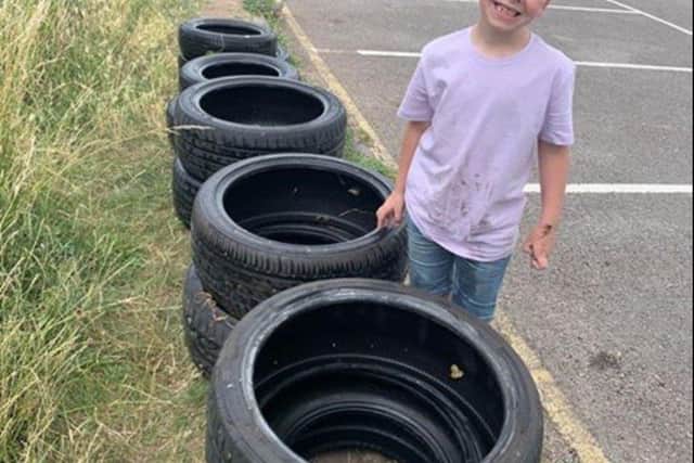 Darcey Harbut, seven, stacked the retrieved tyres. Darcey was concerned wildlife could become trapped.