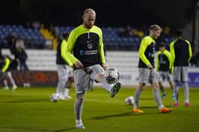 Connor Ogilvie warming-up before his comeback at Cambridge United. However, he collected another injury eight minutes into his return. Picture: Jason Brown/ProSportsImages