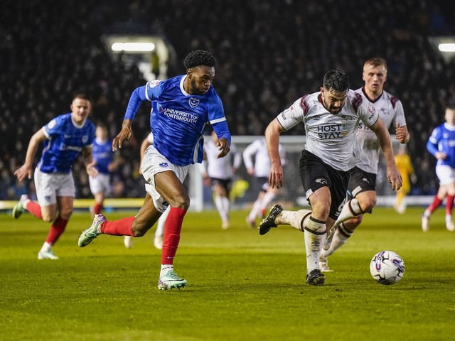 Pompey winger Abu Kamara takes on Eiran Cashin