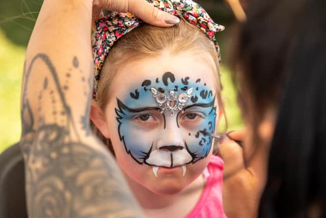 Annira Snook (8) has her face painted at the festival. Picture: Mike Cooter (210522)