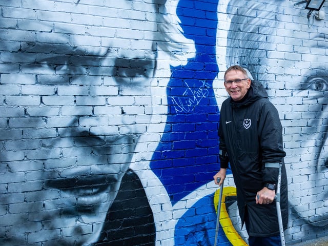 Alan Knight stands next to his picture on the mural which is on the side of the Pompey club shop on Anson Road.