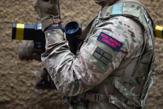 The badge on the arm of a Royal Marines Commando as they prepare to storm a compound during a live exercise demonstration at Bovington Camp in Dorset. The Royal Marines are to be transformed into a new Future Commando Force (FCF) to be deployed around the world on an "enduring basis" in a major overhaul of the armed forces