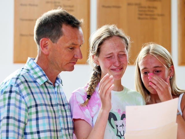 Tears of joy for Maddy Oliver who is going to read geography at Oxford. She is pictured with her father, Graeme, and sister, Beatrice. A-level results, Portsmouth High School, Southsea. Picture: Chris Moorhouse (jpns 180822-14)