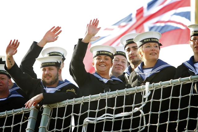 Sailors wave to their loved ones as the Type 45 Destroyer HMS Dauntless returns home to Portsmouth from her maiden deployment. PRESS ASSOCIATION Photo. Picture date: Tuesday October 30, 2012. Hundreds of family members lined the quayside to welcome home the crew of one of the Royal Navy's most advanced warships as it returned from its maiden deployment. HMS Dauntless returned from its seven-month voyage circumnavigating the Atlantic Ocean. See PA story DEFENCE Dauntless. Photo credit should read: Chris Ison/PA Wire