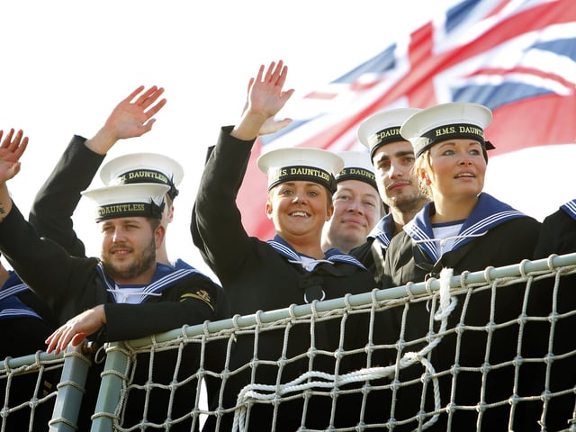 Sailors wave to their loved ones as the Type 45 Destroyer HMS Dauntless returns home to Portsmouth from her maiden deployment. PRESS ASSOCIATION Photo. Picture date: Tuesday October 30, 2012. Hundreds of family members lined the quayside to welcome home the crew of one of the Royal Navy's most advanced warships as it returned from its maiden deployment. HMS Dauntless returned from its seven-month voyage circumnavigating the Atlantic Ocean. See PA story DEFENCE Dauntless. Photo credit should read: Chris Ison/PA Wire
