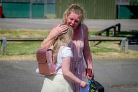 Cara Cooper with her daughter India at the end of the school day.
Picture: Habibur Rahman