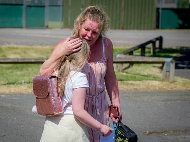 Cara Cooper with her daughter India at the end of the school day.
Picture: Habibur Rahman