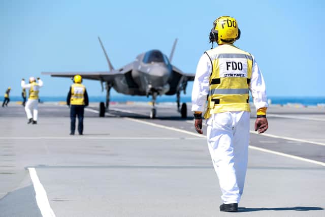 F-35s from 617 Squadron known as 'The Dambusters' landed on the warship this afternoon for the very first time. Photo shows crew working with the some of the jets on HMS Queen Elizabeth. Image: Royal Navy