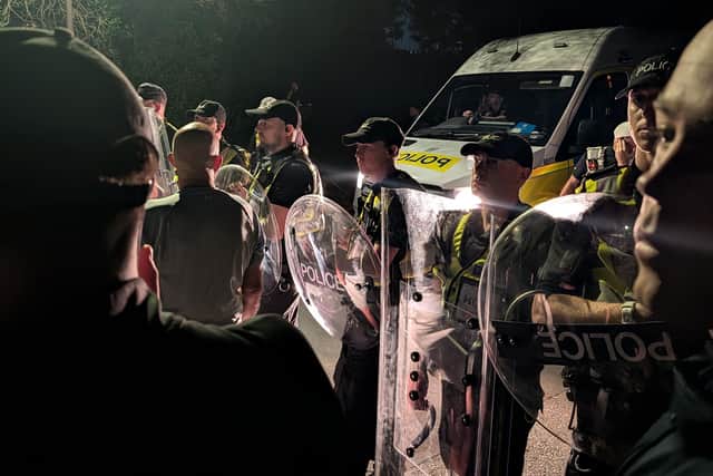 Protesters gathered in Portsmouth after a small boat containing asylum seekers was brought to shore. PIC: Jamie Lashmar/PA Wire