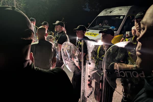 Protesters gathered in Portsmouth after a small boat thought to be containing asylum seekers was brought to shore. PIC: Jamie Lashmar/PA Wire