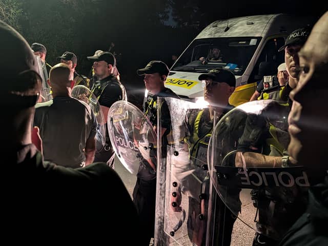 Protesters gathered in Portsmouth after a small boat thought to be containing asylum seekers was brought to shore. PIC: Jamie Lashmar/PA Wire