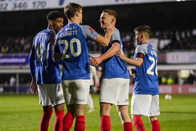Colby Bishop, right centre, is surrounded by his Pompey team-mates following his goal in Friday night's 3-1 win at Hereford in the FA Cup