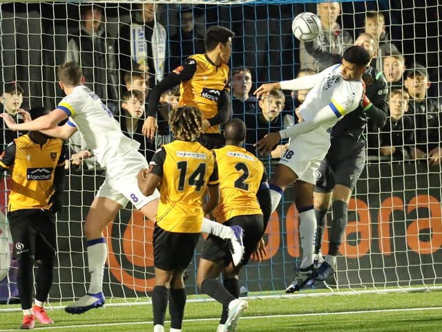 Maidstone keeper Ryan Sandford punches the ball away from Oscar Gobern. Picture: Dave Haines