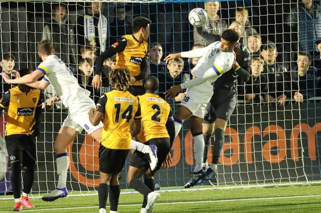 Maidstone keeper Ryan Sandford punches the ball away from Oscar Gobern. Picture: Dave Haines