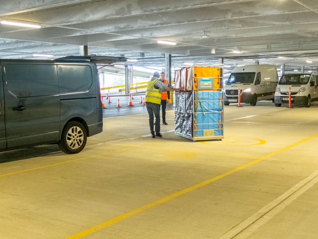 Goods being packed into vans for delivery
