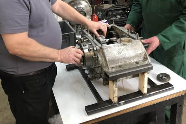 Senior Engineer Ian Stanfield (left) inspects the gearbox with workshop volunteer Phil Hibbard
