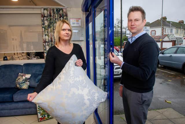 Manager Kerry Hammond with one of the cushions left behind and sales director Matthew Gingell near the exit of the showroom where the sofas were stolen Picture: Habibur Rahman