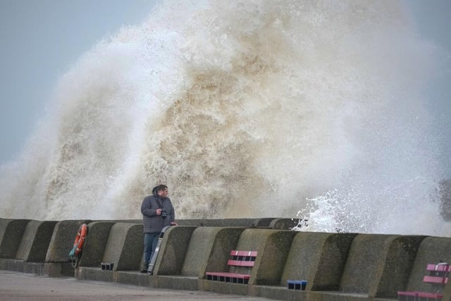 People view the waves created by high winds and spring tides hitting the sea wall at New Brighton promenade on Thursday afternoon as the nation waits for Storm Eunice in the wake of Storm Dudley. (Photo by Christopher Furlong/Getty Images)