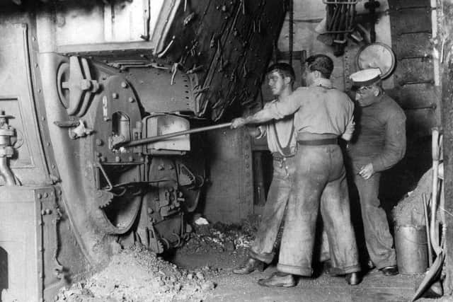 Royal Navy stokers raking out a boiler in Portsmouth Dockyard in 1910