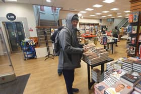 Peter, 69, grabbing a copy of Prince Harry's new book Spare, but not for himself. Picture: Habibur Rahman.