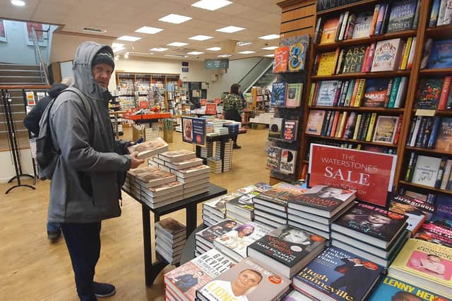 Peter, 69, grabbing a copy of Prince Harry's new book Spare, but not for himself. Picture: Habibur Rahman.