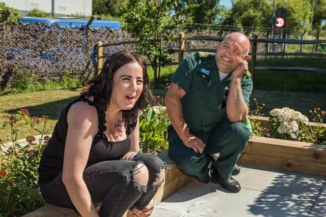 A light-hearted moment as Kirsty Hext (26) chats with Paramedic Tim Ray (51). Picture: Mike Cooter (090621)