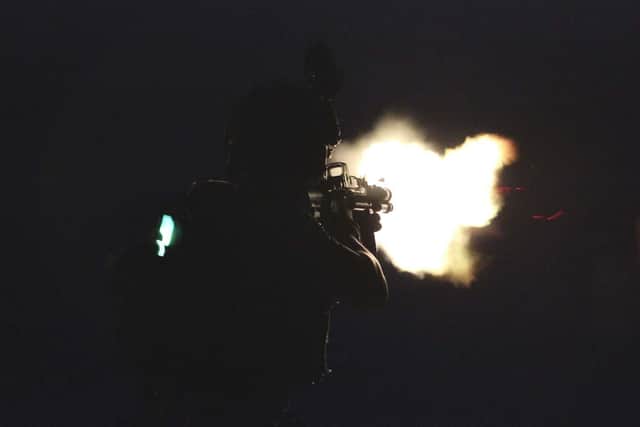 A Royal Marine on HMS Montrose practises shooting at night as Montrose hits the waters of the Gulf once again.