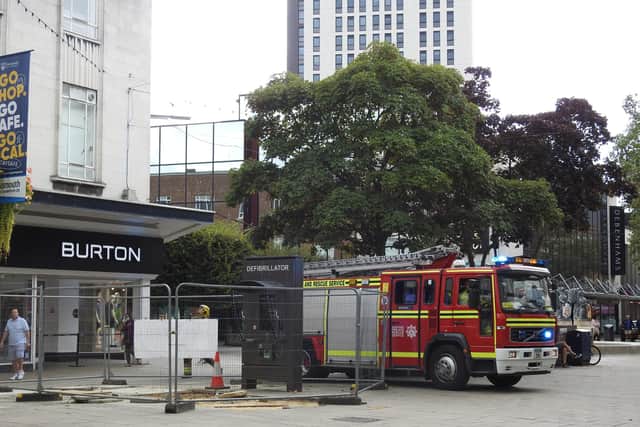 Fire crews attend a fire next to a retail outlet.