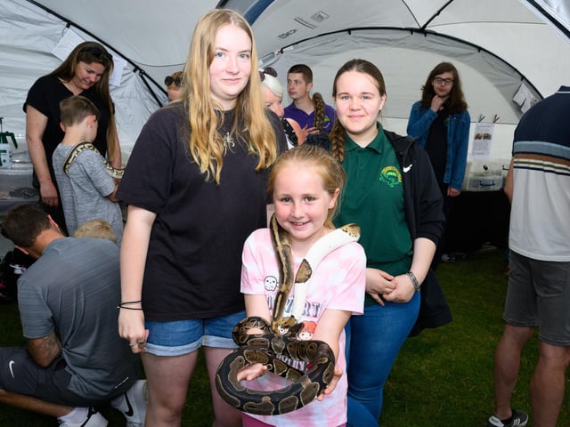 Pictured is: Natasha and Charlie with Amelia Day who holds Julia and Romeo the Pythons from the Portsmouth Reptile and Amphibian SocietyPicture: Keith Woodland (230621-63)