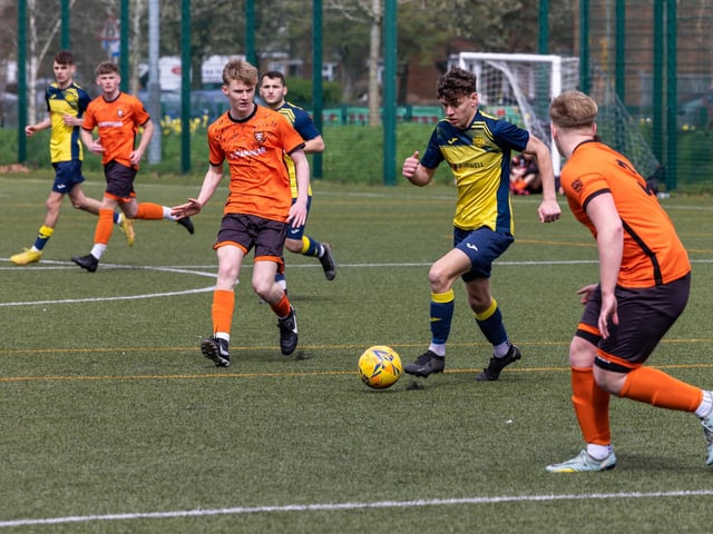 Action from the 2-2 draw between the under-18s of Moneyfields (blue/yellow kit) and AFC Portchester (orange/black kit). Picture: Mike Cooter