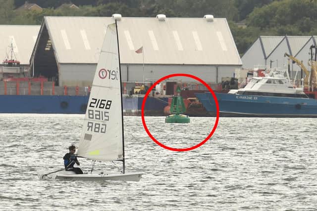 Pictured:  The rib struck this green buoy (circled) in Southampton water.  View across from Weston Shore to Hythe. Picture: Simon Czapp/Solent News & Photo Agency