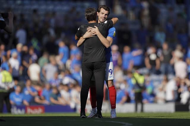John Marquis hugs Pompey boss Danny Cowley