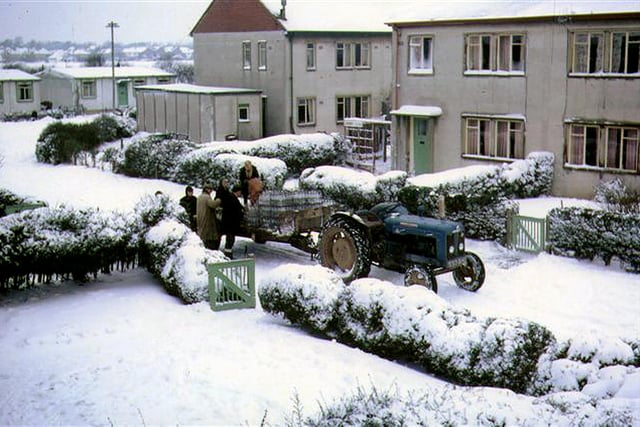 Milk being delivered by farm tractor and trailer in Cherry Close, Lee-on-the-Solent, during the big freeze in December 1963.