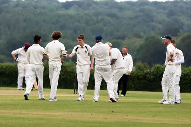 Hambledon 3rds bowler Elliot Jenkins is congratulated after dismissing Havant 3rds opener Tom Wragg. Picture: Sam Stephenson