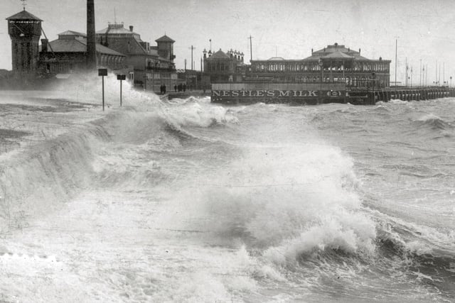 A rough sea breaks over Clarence Pier about 1910