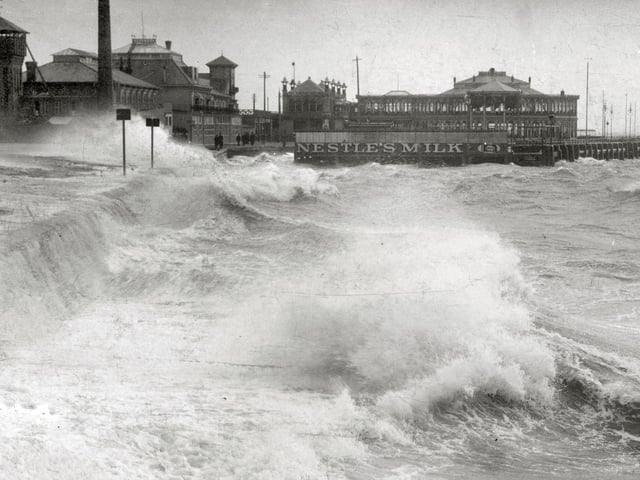 A rough sea breaks over Clarence Pier about 1910