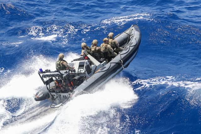 Royal Marines pictured charging towards one of the ships smuggling drugs through the Caribbean. Photo: Royal Navy