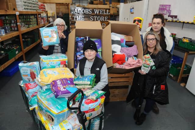 Jacobs Well Care Centre, in Toronto Place, Gosport, are taking donations and hoping to fill a truck worth of supplies to Ukraine. Pictured is: (l-r) Angela Pottinger)70), Rogan Morrill (12), Lorraine Pottinger (51), manager, and Cherish-Star Pottinger (30) with just some of the donations they have received in less than 24 hours. Photo: Sarah Standing (280222-9831)