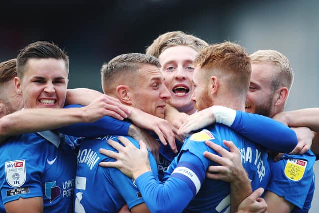 Tom Naylor is congratulated by his Pompey team-mates after netting the opening goal in Saturday's 2-1 win over MK Dons. Picture: Joe Pepler
