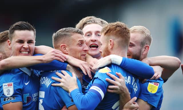 Tom Naylor is congratulated by his Pompey team-mates after netting the opening goal in Saturday's 2-1 win over MK Dons. Picture: Joe Pepler