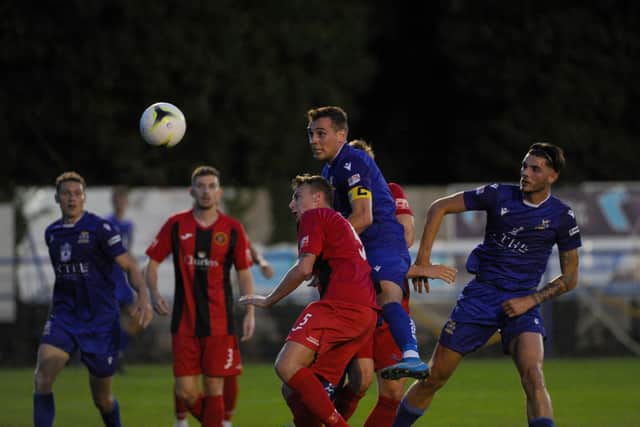 Baffins captain Jason Parish (middle) in FA Cup action against Winchester City. Picture: Sarah Standing
