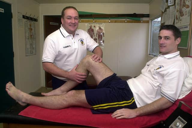 Flashback - Phil Ashwell gives treatment to Hawks player Chris Ferrett in 2003. Pic: Jon Brady.