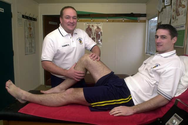 Flashback - Phil Ashwell gives treatment to Hawks player Chris Ferrett in 2003. Pic: Jon Brady.